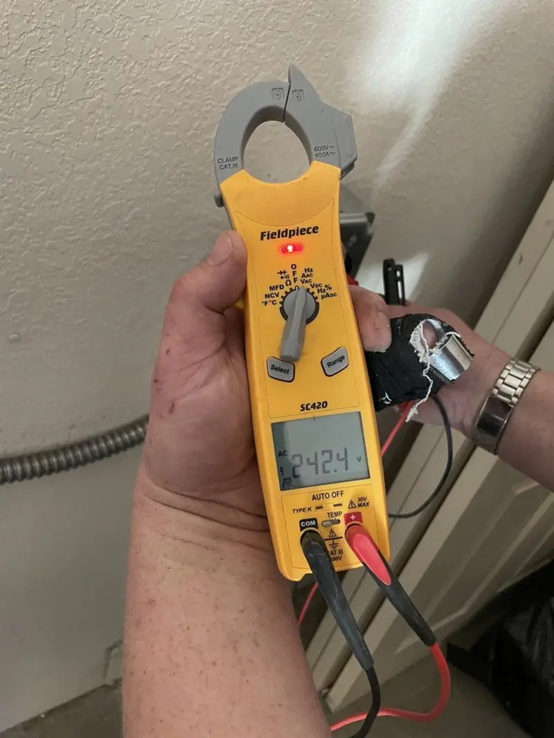 Voltage testing with clamp meter during Ceiling Fan Installation in Pecan Plantation